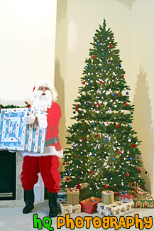 Santa Claus Holding a Present painting