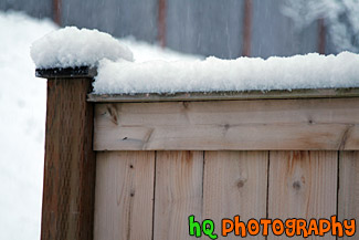 Snow Falling on Fence