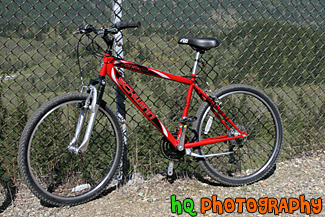 Red Mountain Bike Against Fence