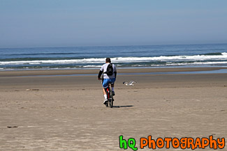 Man Riding Bike on Beach