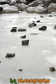 Frozen Rocks on Icy Water