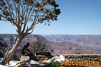 Man Playing Guitar Along Rim of Grand Canyon