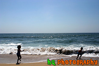 Kids Running Away from Ocean Waves
