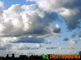 Puffy Clouds Over Farm