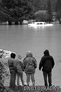 People Watching Car in Flood black and white picture