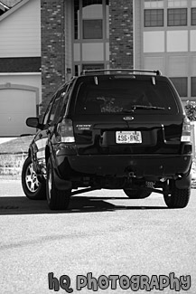 Black SUV Turning Around Corner black and white picture