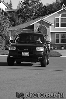 SUV Driving on Road black and white picture