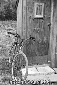 Old Bicycle Leaning Against Shed black and white picture