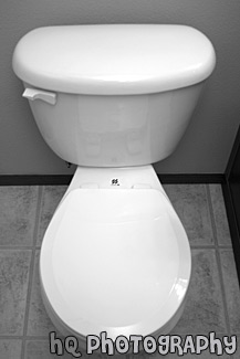 White Toilet With Seat Down black and white picture
