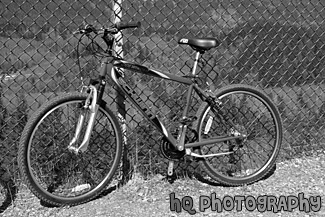 Red Mountain Bike Against Fence black and white picture