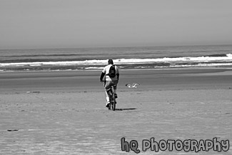 Man Riding Bike on Beach black and white picture