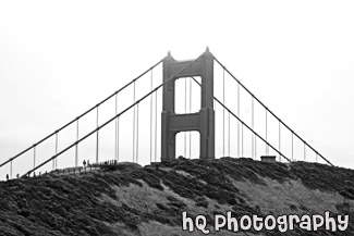 Tip of Golden Gate Bridge Behind Hill black and white picture