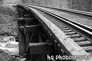 Railroad Tracks Over Bridge black and white picture