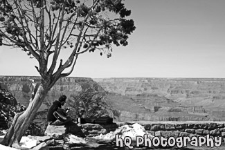 Man Playing Guitar Along Rim of Grand Canyon black and white picture