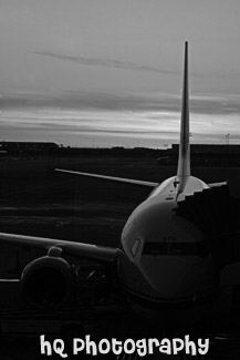 Airplane at Terminal During Sunset black and white picture