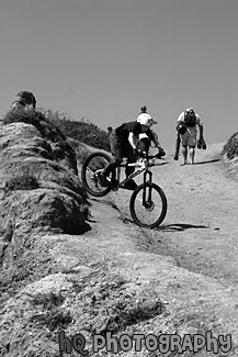 Kid Riding Bike Down a Hill black and white picture