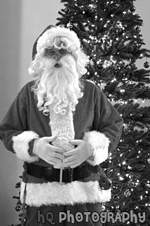 Santa Standing in Front of Christmas Tree black and white picture