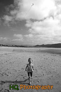 Little Girl Running on Beach with Kite black and white picture