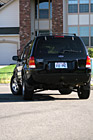 Black SUV Turning Around Corner photo thumbnail