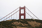 Tip of Golden Gate Bridge Behind Hill photo thumbnail