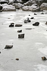Frozen Rocks on Icy Water photo thumbnail