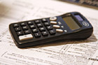Black Calculator on Tax Forms photo thumbnail