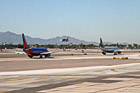 Planes Taxing and Landing at Airport photo thumbnail