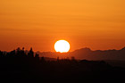 Big Sun Setting Over Olympic Mountains photo thumbnail
