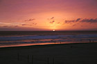 Sun Setting Behind Ocean photo thumbnail