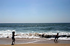 Kids Running Away from Ocean Waves photo thumbnail