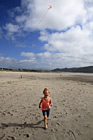 Little Girl Running on Beach with Kite photo thumbnail