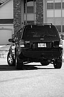 Black & White Black SUV Turning Around Corner preview