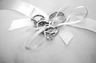 Black & White Wedding Rings Tied on Pillow preview