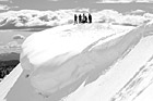 Black & White People on Top of Snowy Hill for Snowshoe Trip preview