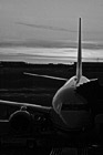 Black & White Airplane at Terminal During Sunset preview