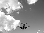 Black & White Airplane Overhead in Sky preview