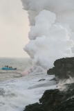 Lava Flowing Into The Pacific Ocean and a Boat