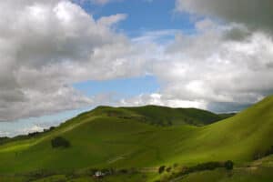 Green Hill With Puffy Clouds Photo